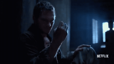 Man Holding Glowing Netflix Logo GIF