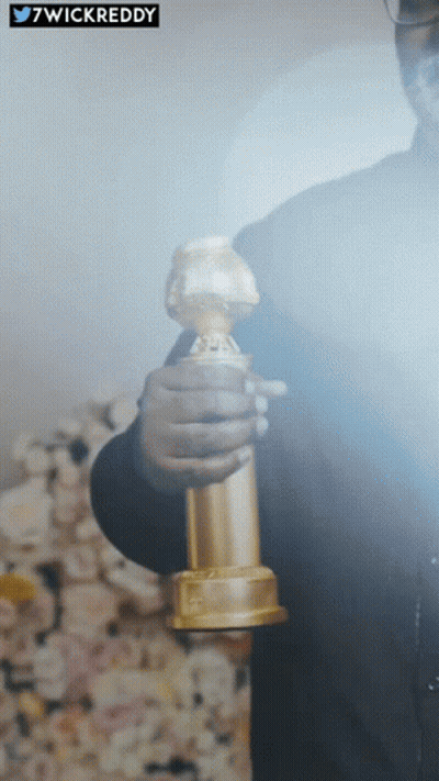 Man Holding Golden Globes Behind 7Wickreddy Sticker GIF
