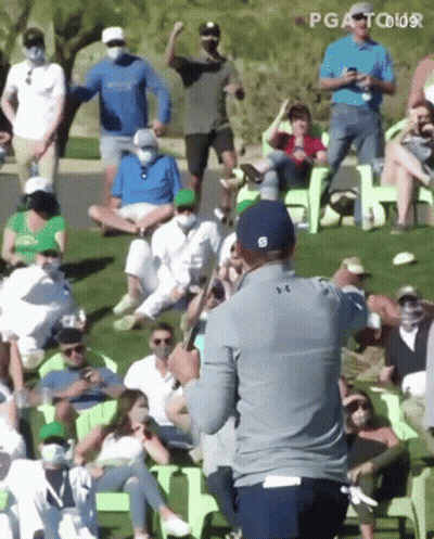 Man Holding Golf Club In Front Of Crowd GIF
