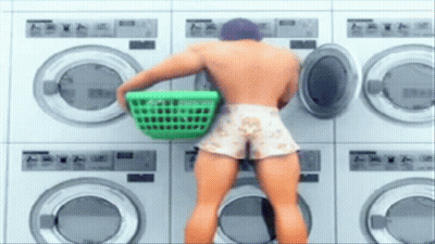 Man Holding Green Laundry Basket At Laundromat GIF