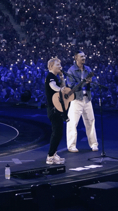 Man Holding Guitar And Singer At Microphones GIF