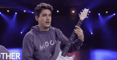 Man Holding Guitar Wearing Moon Shirt GIF