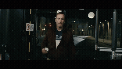Man Holding Gun By Sign Saying Please Keep Back Of Yellow Line GIF