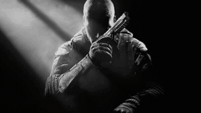 Man Holding Gun In Dark Room GIF