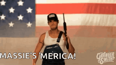 Man Holding Gun In Front Of American Flag Saying Massie 'S Merica GIF