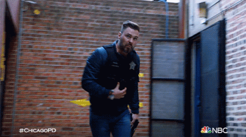 Man Holding Gun In Front Of Brick Wall Chicagopd GIF