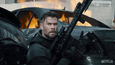 Man Holding Gun in Front of Burning Car Netflix