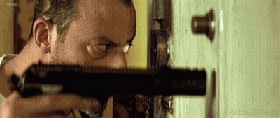 Man Holding Gun In Front Of Door With Giantmonster GIF