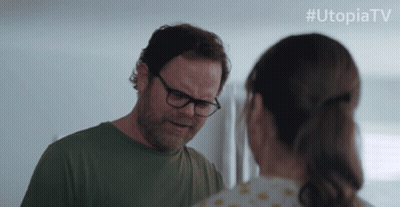 Man Holding Gun In Front Of Door With UtopiaTV GIF
