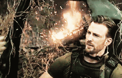 Man Holding Gun In Front Of Fire GIF