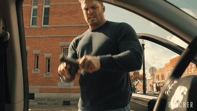 Man Holding Gun In Front Of Reacher Logo GIF