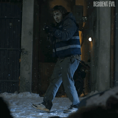Man Holding Gun In Front Of Resident Evil Building GIF