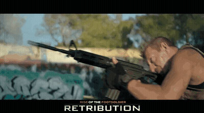 Man Holding Gun In Front Of Retribution Wall GIF