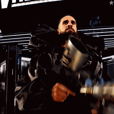 Man Holding Gun In Front Of Wrestleview Sign GIF
