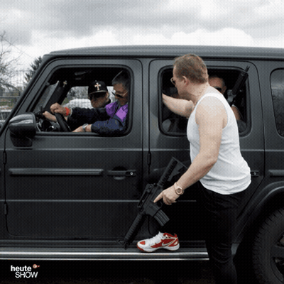 Man Holding Gun Next To Car Saying Heute Show GIF