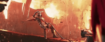 Man Holding Gun On Bridge In Front Of Fire GIF
