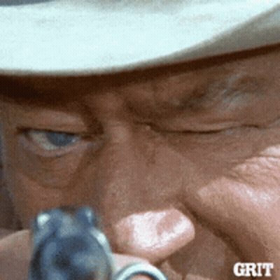 Man Holding Gun Saying Grit GIF