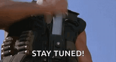 Man Holding Gun Saying Stay Tuned GIF