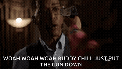 Man Holding Gun Saying Woah Chill GIF