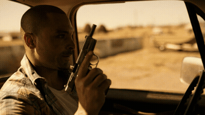 Man Holding Gun Sitting In Car GIF