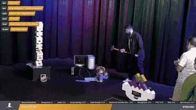 Man Holding Hammer in Front of $700,000 Screen