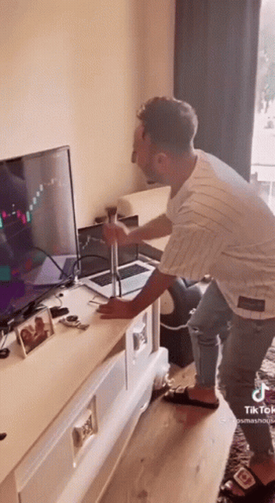 Man Holding Hammer In Front Of TV GIF