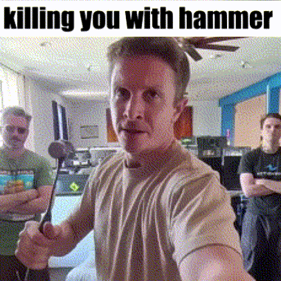 Man Holding Hammer In Living Room With Others Behind Him GIF
