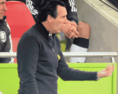 Man Holding Hand To Forehead In Front Of Arsenal Sign GIF