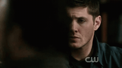 Man Holding Hand To Forehead In Front Of CW Logo GIF