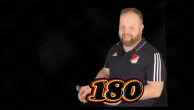 Man Holding Hand Up In Front Of Dart Board Saying Ticker Is Ticker GIF