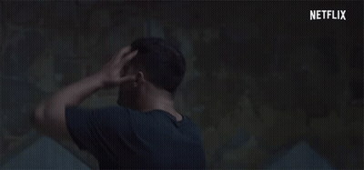 Man Holding Head In Dark Room With Netflix Logo GIF