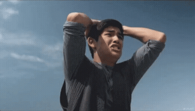Man Holding Head In Front Of Blue Sky GIF