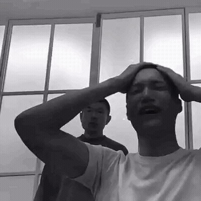 Man Holding Head In Front Of Blue Sky GIF