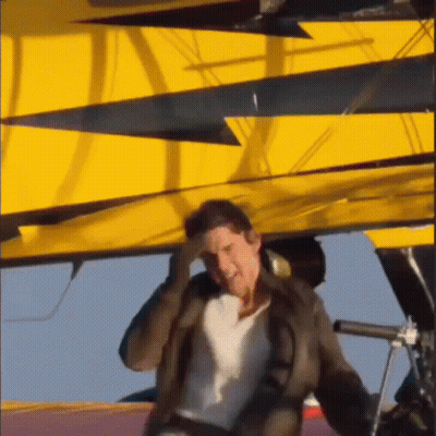 Man Holding Head In Front Of Yellow Crane GIF