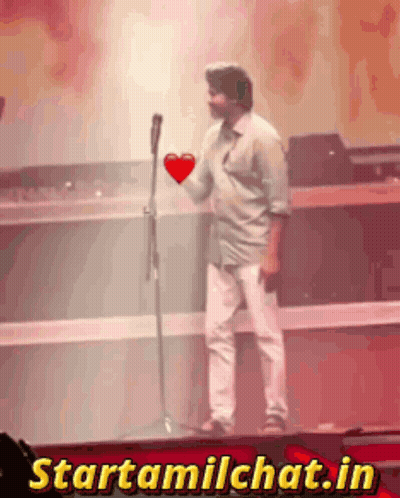 Man Holding Heart In Front Of Microphone Starttamilchat.in GIF