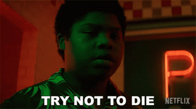 Man Holding Hot Dog By Try Not To Die Sign GIF