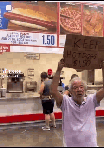 Man Holding Keep Hot Dogs $1.50 Sign GIF