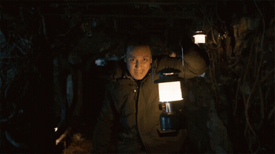 Man Holding Lantern In Dark Forest GIF