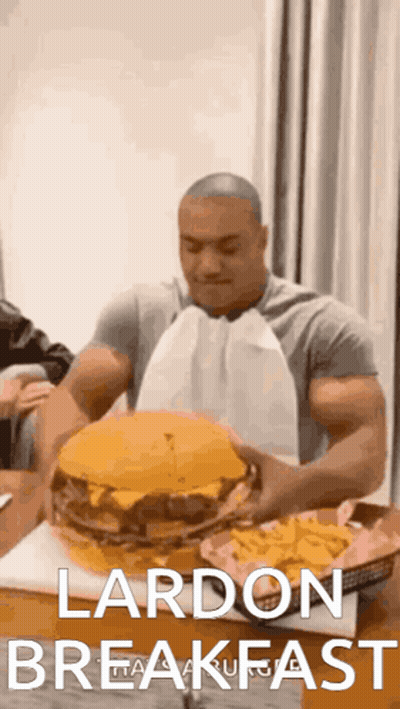 Man Holding Large Hamburger And French Fries GIF