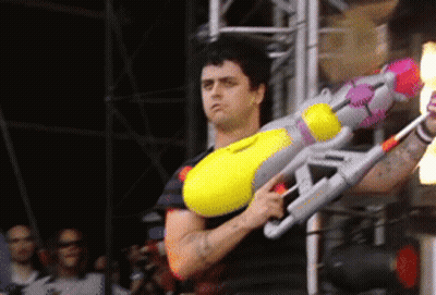 Man Holding Large Yellow Water Gun GIF