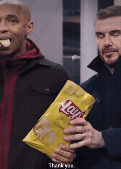 Man Holding Lays Chips While Another Eats GIF