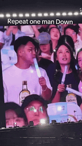 Man Holding Light Stick In Front Of Crowd Repeat One Man Down GIF