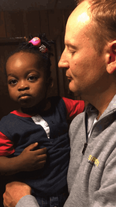 Man Holding Little Girl In Grey SEO Sweatshirt GIF