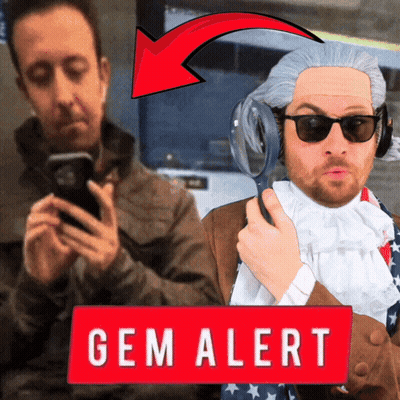 Man Holding Magnifying Glass Next To Gem Sign GIF