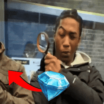 Man Holding Magnifying Glass Over Blue Diamond GIF
