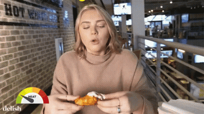 Man Holding Microphone Eating Red Pepper GIF