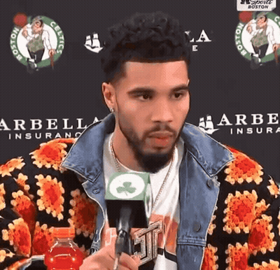 Man Holding Microphone In Front Of Arbella Insurance GIF