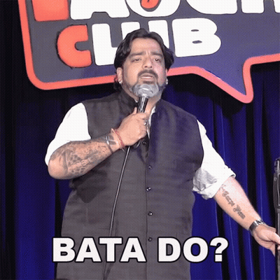 Man Holding Microphone In Front Of Bata Do Sign GIF