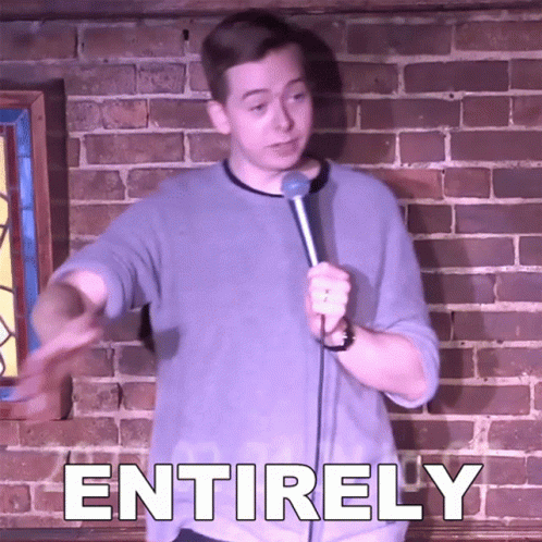 Man Holding Microphone In Front Of Brick Wall With Entirely GIF
