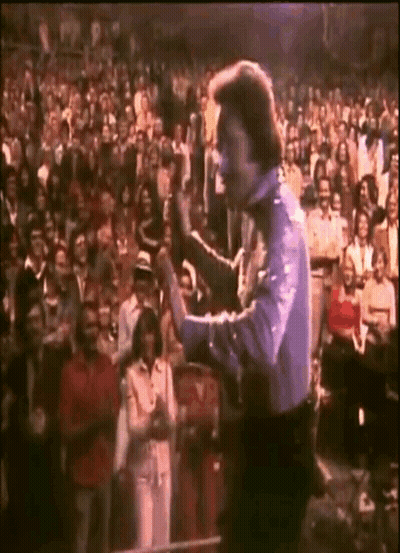 Man Holding Microphone In Front Of Crowd GIF